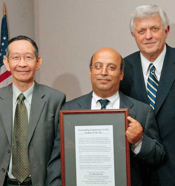 Dr. Ahmed Al-Ostaz (with plaque), professor of mechanical engineering