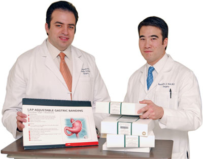 Dr. Salameh and Dr. Vick stand with educational materials about the laparosopic band
