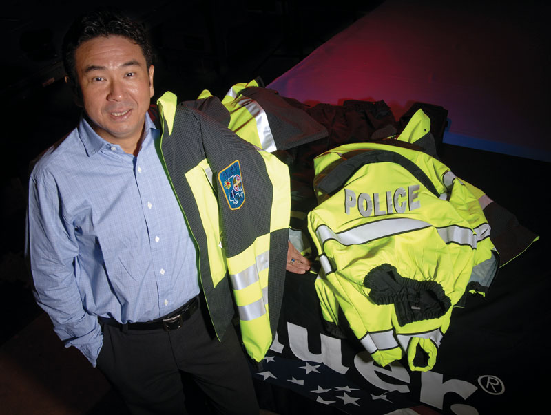 Seiji Endo stands with customized police gear