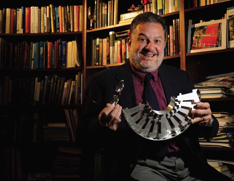 Dr. Lucien Cremaldi, UM particle physicist, holds one of the first models of a mechanical and cooling frame fabricated at UM for the Forward Pixel detector. The detector is currently installed in the CMS experiment at the LHC. The experiment is designed to search for new forms of matter existing in the early universe.