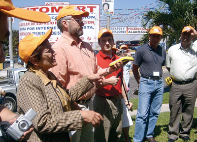 Easson demonstrating a GPS unit in a commercial area